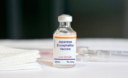 Vital of Japanese encephilities vaccine on a white table with label clearly visible  